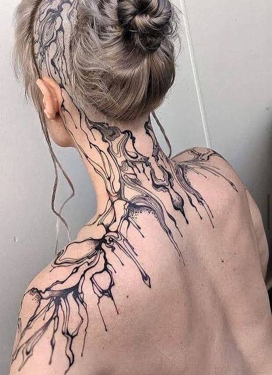 the back of a woman's neck with tree branches on her upper and lower part