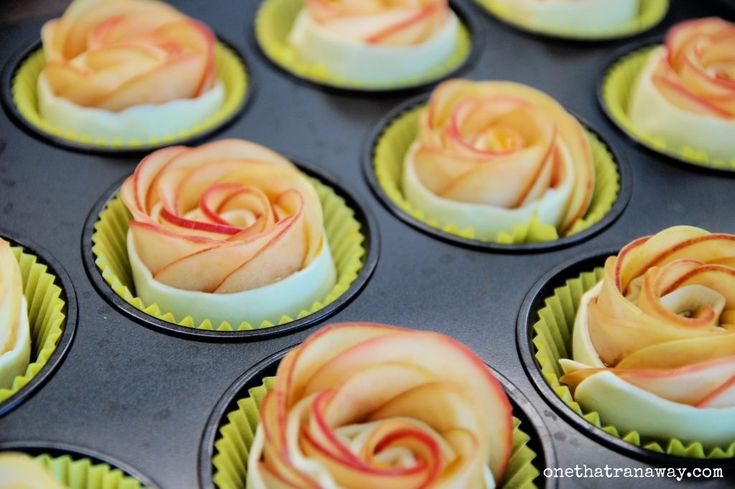 cupcakes decorated with orange and white frosting in a muffin tin