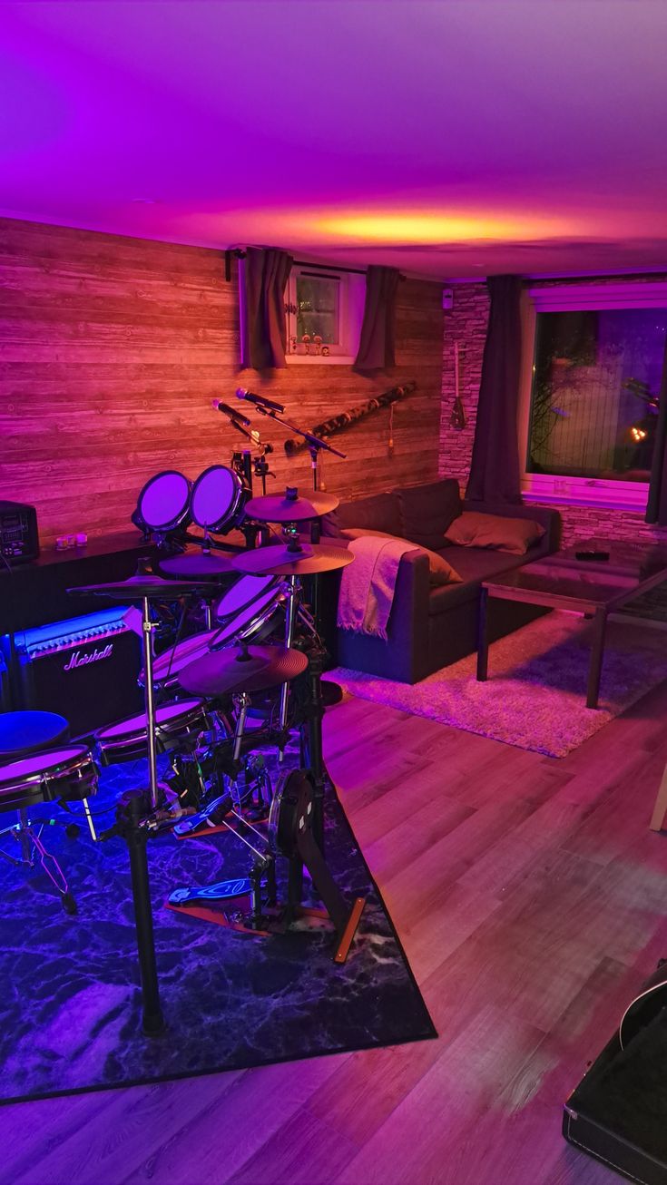 a living room filled with furniture and musical equipment