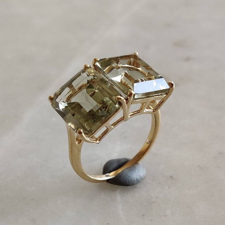 ITEM DESCRIPTION: --> The ring is made from Solid 14K Yellow Gold. Gemstone used is absolutely natural and ethically sourced. --> Emerald Cut Green Amethyst in prong setting is studded on it with utmost precision and finesse. Gemstone: Green Amethyst Gem size: 12x10 mm (2 pcs) Gem weight: 11.50 carat Gold purity: 14K (58.33% approx.) Gold weight: 2.98 grams Gross weight of ring: 5.28 grams >>The Gold purity is guaranteed and it comes with authentic 14K gold hallmark. >>Since these Rings are hand Green Amethyst Jewelry, Green Amethyst Ring, Handmade Jewelry Box, Amethyst Gem, Amethyst Jewelry, February Birthstone, Green Amethyst, February Birth Stone, Yellow Gold Ring