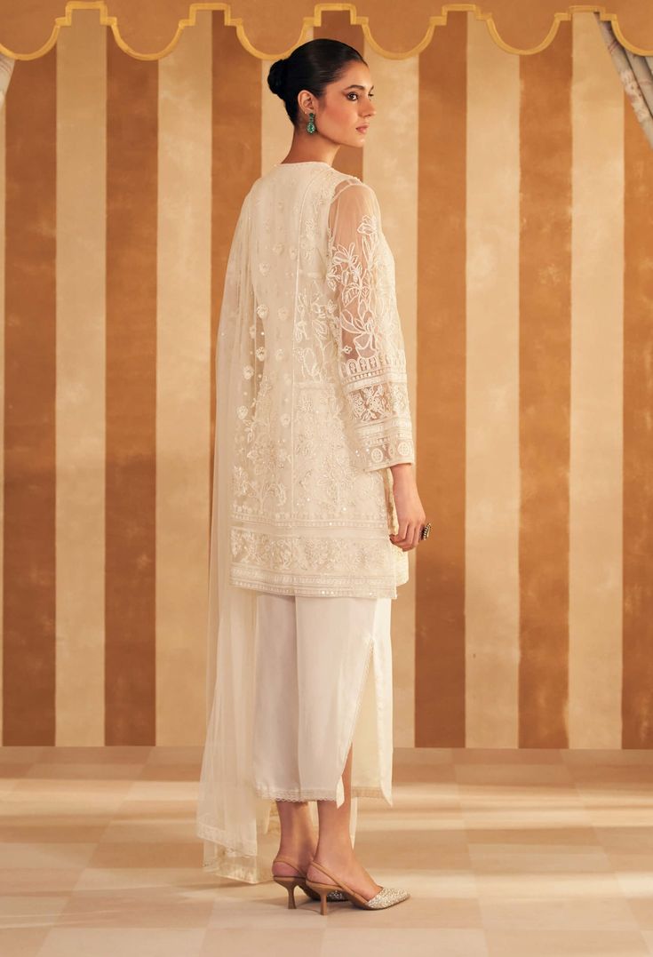 Step into refined elegance with the ivory new embroidered kurta, perfectly paired with luxurious silk pants and a delicate net embroidered dupatta. The kurta features intricate embroidery in soft ivory, adding a touch of sophistication. The silk pants offer a sleek, complementary finish, while the net dupatta, adorned with delicate embroidery, completes the ensemble with an ethereal charm. Ideal for both festive and formal occasions, this outfit effortlessly blends classic grace with contemporar Elegant Off White Kurta With Dupatta, Elegant Naqshi Dupatta For Reception, Unstitched Chikankari Embroidery Suit For Reception, Reception Unstitched Chikankari Embroidery Straight Kurta Suit, White Palazzo Set With Intricate Embroidery, White Palazzo Set With Sheer Dupatta And Straight Kurta, White Straight Kurta With Sheer Dupatta, Off White Palazzo Set With Intricate Embroidery For Eid, Off White Palazzo Set With Resham Embroidery