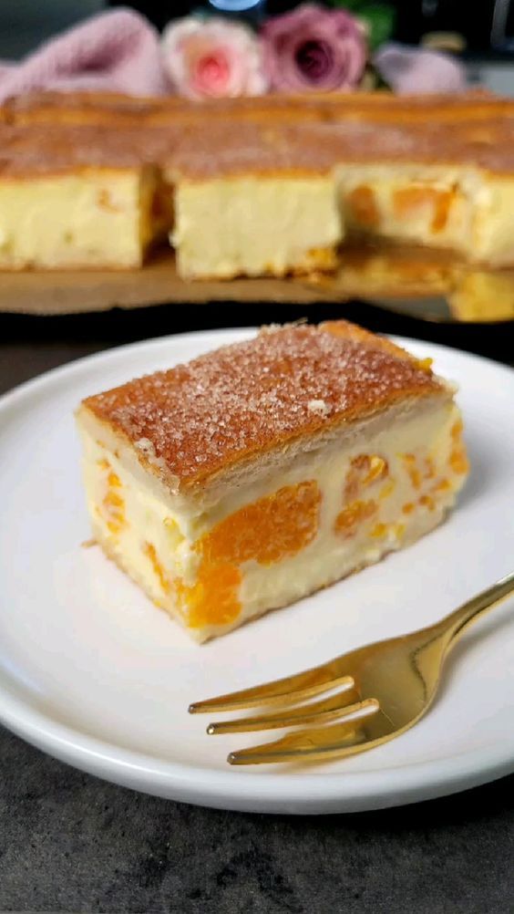 a piece of cake sitting on top of a white plate next to a knife and fork