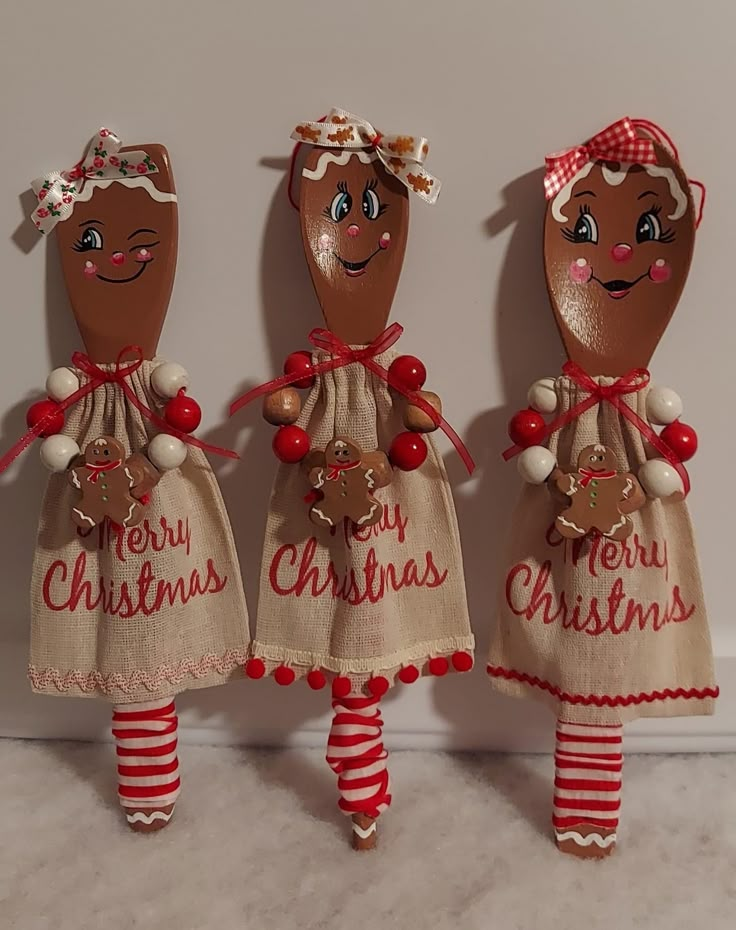 three christmas dolls are standing next to each other in burlocks and red striped stockings