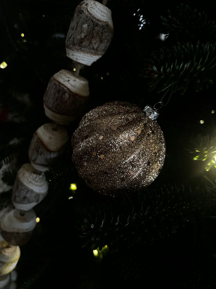 an ornament hanging from the top of a christmas tree