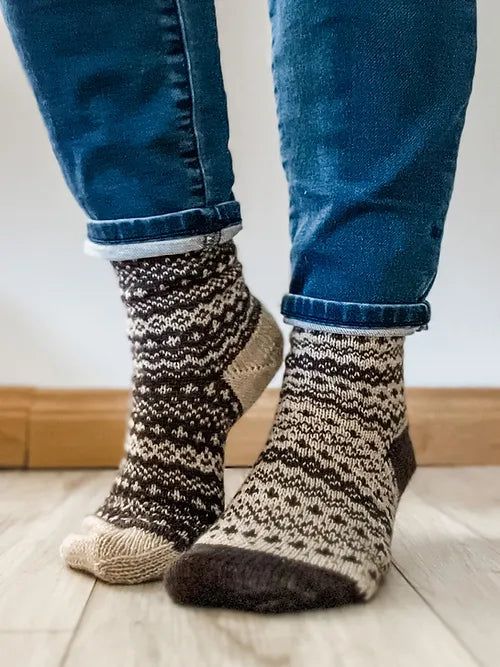 the legs of a person wearing socks and jeans