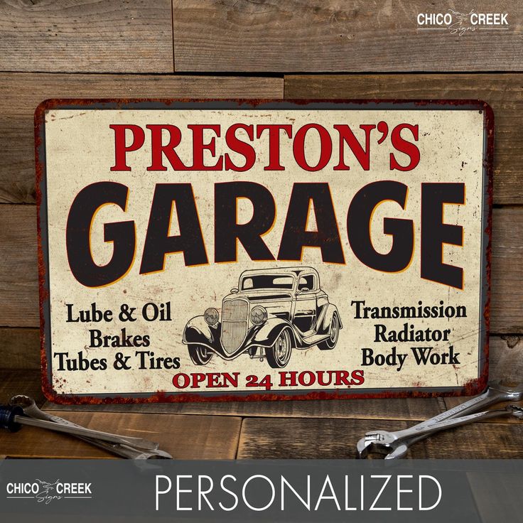 personalized garage sign with wrens on wooden background