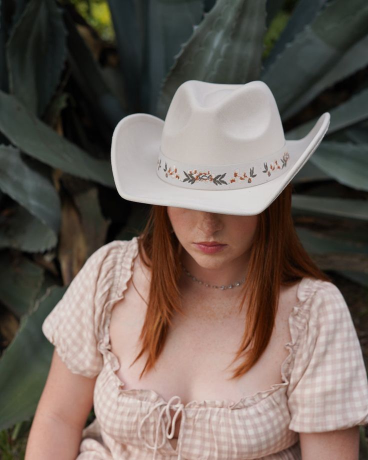 Add a touch of western glam to your outfit with our Cream Floral Embroidered Strap Cowboy Hat! This cute white cowboy hat features a strap embroidered with pretty flower details and pairs well with virtually anything. White Western Felt Hat For Kentucky Derby, White Western Felt Hat For The Beach, White Western Hat For Spring, White Country Style Felt Hat For Beach, Country Style White Felt Hat For Beach, White Country Style Felt Hat For The Beach, White Wide Brim Felt Hat For Spring, Country Style White Felt Hat For The Beach, White Flat Brim Felt Hat For Spring