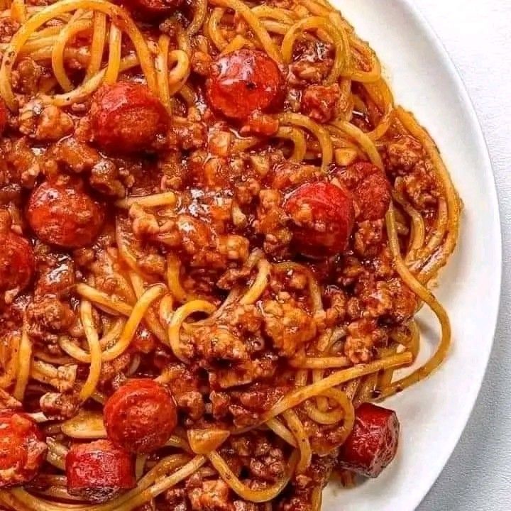 a white plate topped with spaghetti and meatballs