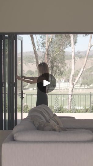 a woman standing in front of a sliding glass door