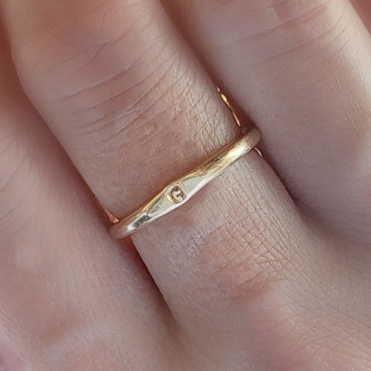 Adorn you hands with this timeless Minimal Initial Signet Ring. Hand-crafted from 14K yellow gold filled, this ultra-chic ring is a perfect gift for moms or couples. It's a unique, minimal piece with the power to carry a special, sentimental message. Rings are handmade in our Indiana studio. There will be a small color difference in the gold where it is soldered together in our studio. Please add initial in the NOTES box at checkout. Gold Simple Initial Ring As Gift, Gold Initial Ring For Gift, Simple Gold Initial Ring As Gift, Gold Simple Initial Ring For Gift, Simple Yellow Gold Initial Ring For Gift, Simple Yellow Gold Initial Ring As Gift, Minimalist Recycled Gold Stackable Rings For Anniversary, Adjustable Yellow Gold Initial Ring, Simple 14k Gold Engraved Ring For Anniversary