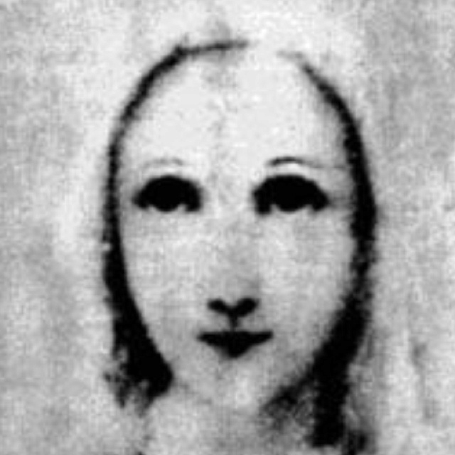 an old black and white photo of a woman's face