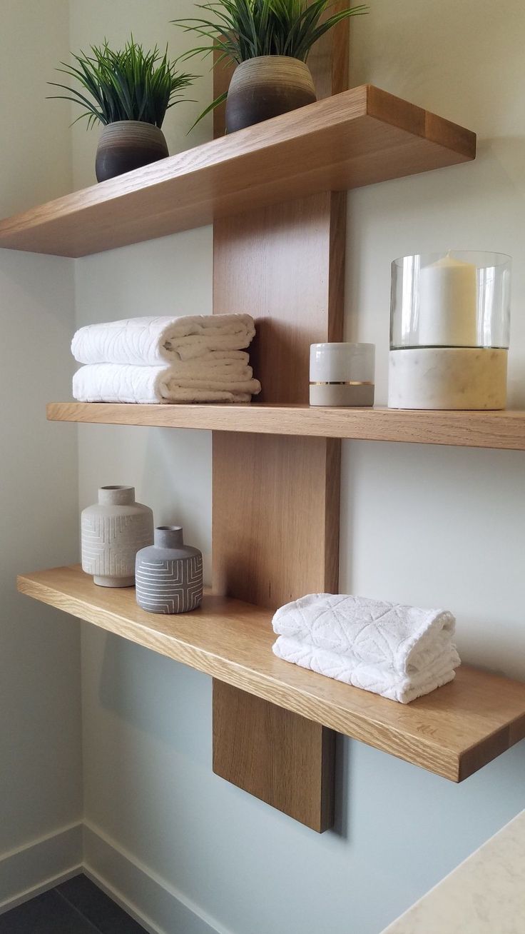 towels and candles are displayed on wooden shelves