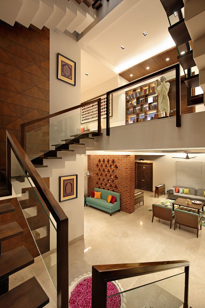 a living room filled with furniture next to a stair case