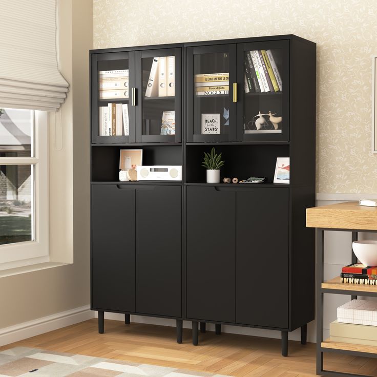 a black bookcase with glass doors in a living room next to a wooden floor