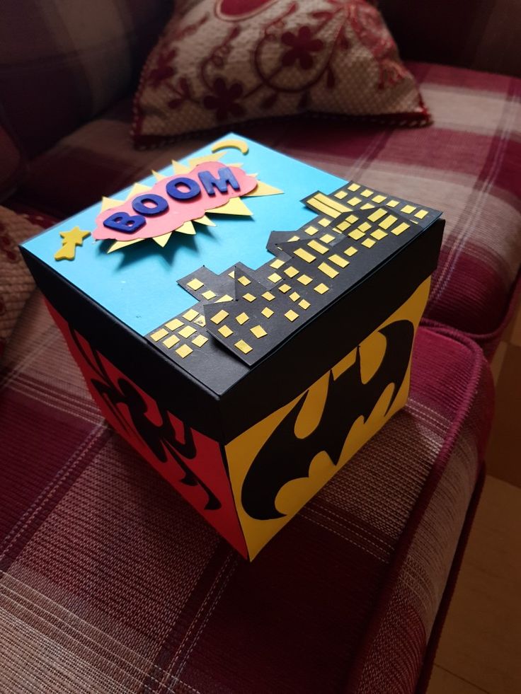 a batman themed box sitting on top of a couch