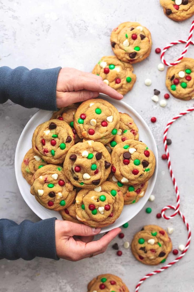 a plate full of chocolate chip cookies with candy canes