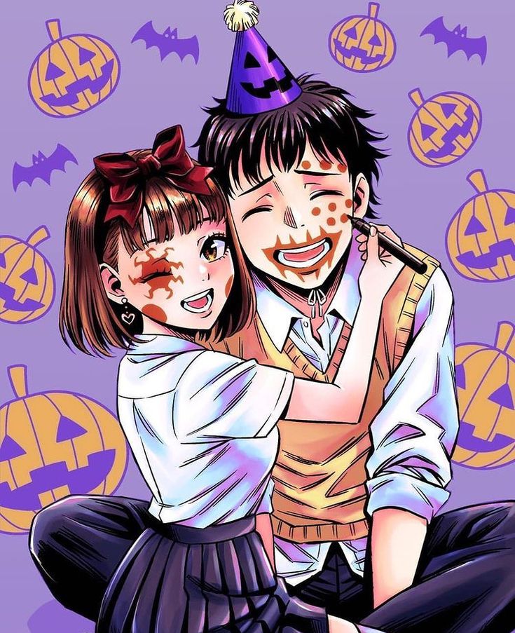 two people sitting on the ground with halloween decorations around them