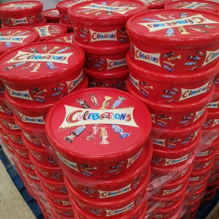 many red plastic containers stacked on top of each other in a store display case with the word celebration written on them