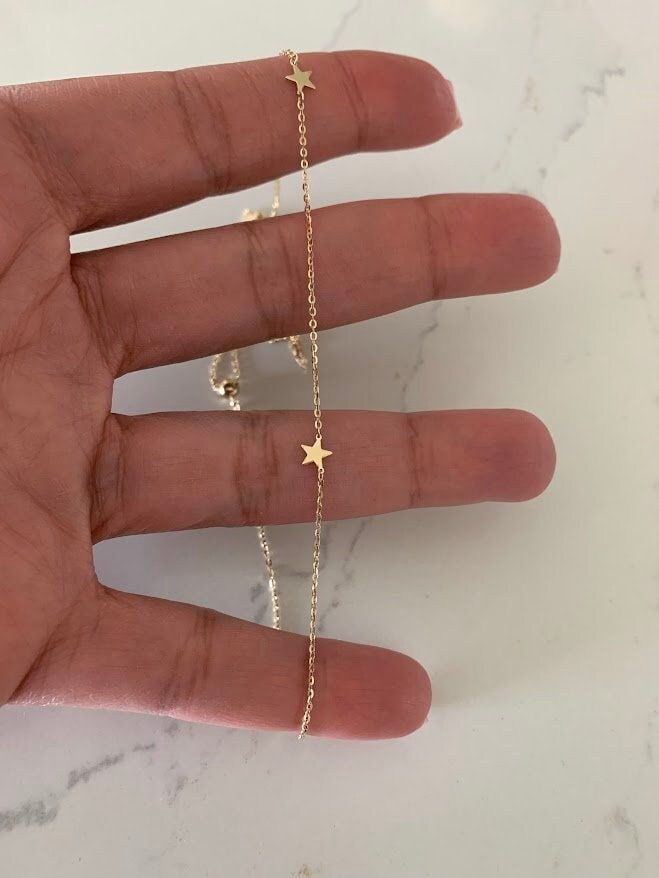 "14k Solid Gold Star Choker Necklace, Dainty Necklace, Layering Necklace, 14K Gold Chain Stars Necklace, Real Gold Necklace, Stars ------------------------------------------------- ♦ --------------------------------------------------- The Stars Choker Necklace is a beautiful, affordable dainty 14K Solid Gold piece of jewelry that is great for everyday wear. It comes available just in yellow gold. This necklace can be used in combination any of our other necklaces for a layering effect. A great i Gold Star Necklace For Anniversary, Gold Jewelry With Star Charm, Yellow Gold Star Necklace With Adjustable Chain, 14k Gold Jewelry With Star Charm, 14k Gold Dainty Jewelry With Star Charm, Dainty 14k Gold Star Charm Jewelry, 14k Gold Star Charm Jewelry Gift, 14k Gold-filled Yellow Gold Star Charm Jewelry, 14k Gold Star Necklace As Gift