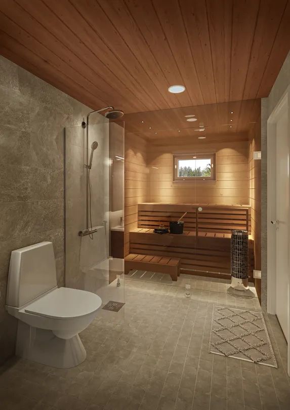 a bathroom with a toilet, shower and wooden paneled walls in the background is a sauna