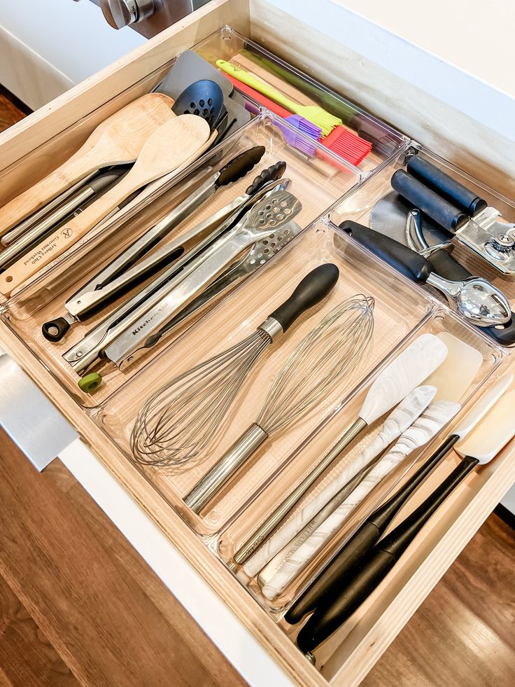 Kitchen utensils organized in a drawer with clear organizers Tubberware Drawer Organization, Large Utensil Drawer Organization, Kitchen Cooking Utensil Organization, Utensil Storage Drawer, Kitchen Drawer Organization Utensils, Utensils Drawer, Organizers For Kitchen, Kitchen Utensil Drawer Organization, Cooking Utensil Organization