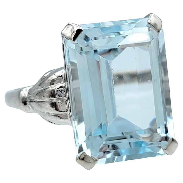 Ring Size: 6.5 Discover the serene beauty of our stunning 10.66 carat emerald-cut aquamarine ring, set in a sleek 14 karat white gold band. This exquisite piece showcases the breathtaking clarity and oceanic hue of the aquamarine, expertly faceted to reflect light and maximize its natural brilliance. The vibrant gemstone’s clear blue tones evoke a sense of calm and elegance, reminiscent of tranquil ocean waves. The thin white gold band offers a minimalist elegance, allowing the striking aquamari Emerald Cut Aquamarine Ring, Aquamarine Solitaire Ring, 2 Carat Diamond Ring, Aquamarine Cocktail Ring, Solitaire Ring Set, Green Tourmaline Ring, Aquamarine Colour, Aquamarine Ring, Diamond Cocktail Rings