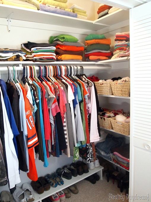 the closet is full of clothes and shoes for all kinds of people to use it