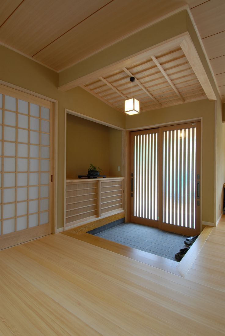 an empty room with sliding glass doors and wood flooring