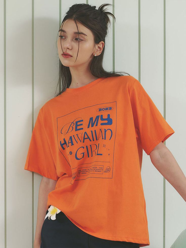 Editor's Notes The oversized shirt has lettering artwork that fits the Hawaiian theme. - Casual and kitsch mood- Oversized fit with a natural silhouette- 20 count 100% cottonMeasurements(in.)ONE SIZE- Shoulder: 16.54 in - Chest: 22.83 in. - Sleeve: 9.45 in. - Total Length: 26.77 in. Model info: Tish - Height 5' 7'' / Lisa - Height 5' 7''  Composition & Care- 100% Cotton- Dry cleaning recommended- If not, wash using a washing netDesigner- by LETTER FROM MOON Oversized Orange Summer T-shirt, Casual Orange Tops With Graphic Design, Casual Orange T-shirt With Screen Print, Orange Short Sleeve T-shirt With Text Print, Oversized Orange T-shirt For Summer, Oversized Orange T-shirt For Streetwear, Orange Relaxed Fit T-shirt With Letter Print, Orange Graphic Print Tops For Streetwear, Summer Orange Tops With Slogan