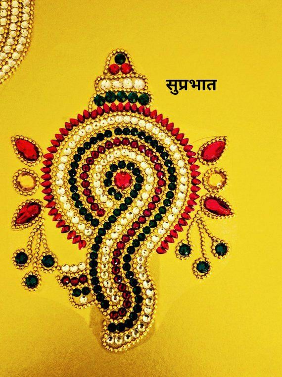 an intricately designed piece of jewelry on a yellow surface