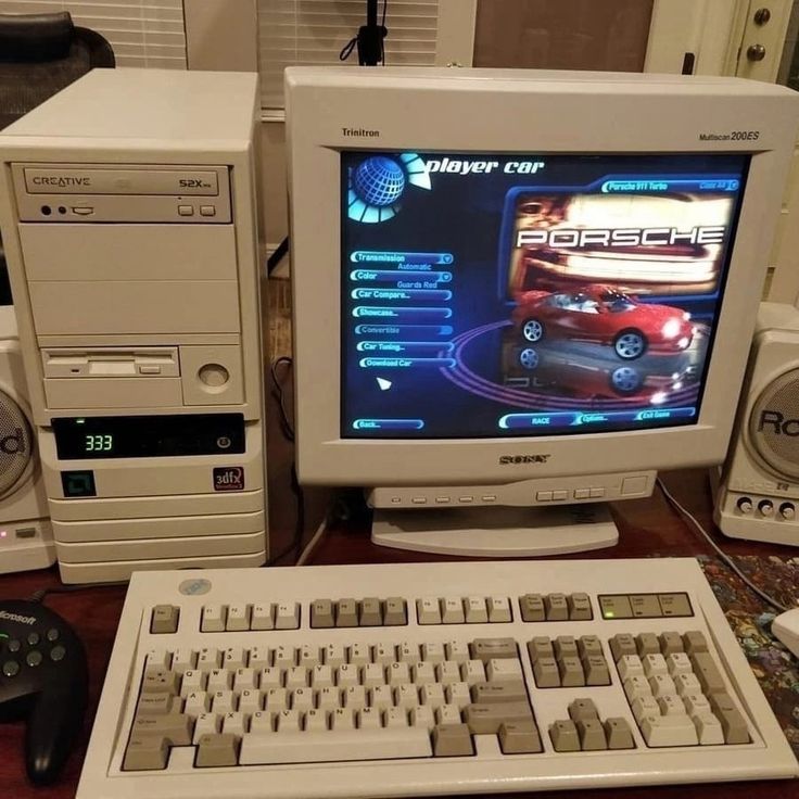 there is a computer with a game on the screen and other electronic equipment around it