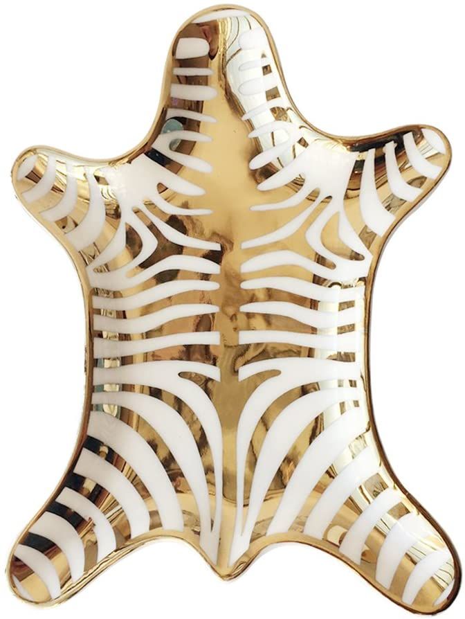 a gold and white plate with zebra stripes on it