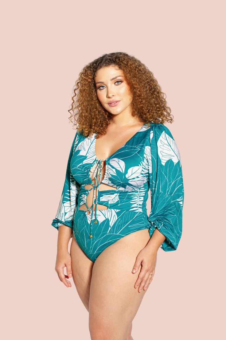 Crisalida Long Sleeve One Piece Swimsuit Tropical V-neck Swimwear With Tropical Print, Summer Tropical Print V-neck Swimwear, Poolside Bodysuit With Lined Body, Tropical V-neck Swimwear For Beach Party, Tropical Stretch Swimwear With Upf 50+, Green One-piece Beachy Swimwear, Beachy Green One-piece Swimwear, Green Beachwear Bodysuit For Beach, Beachwear Bodysuit For Sunbathing With Lined Body