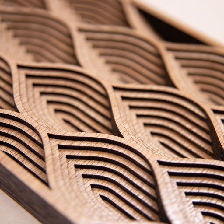 a close up view of some wood carved designs on a piece of plywood material