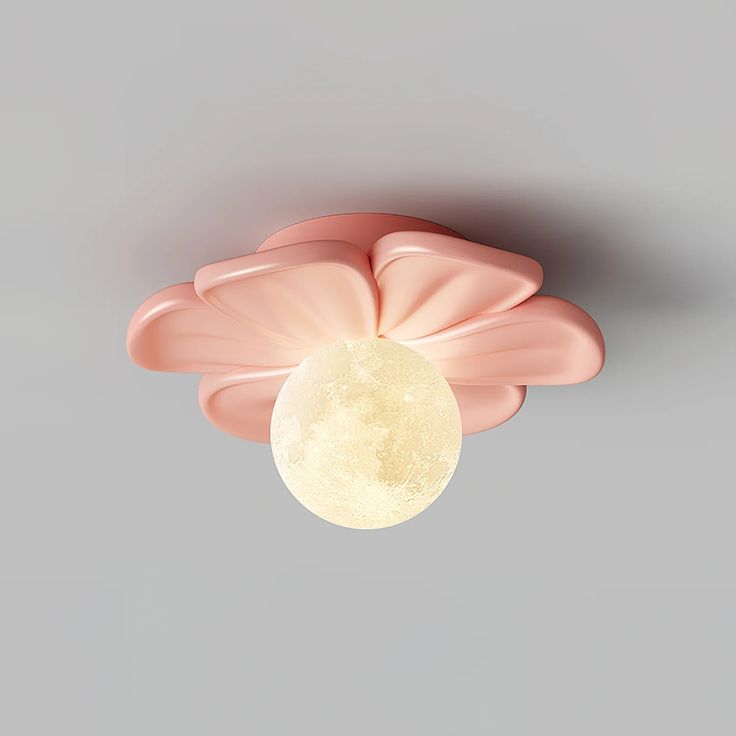 a pink flower with a moon in the center on a gray background that appears to be floating