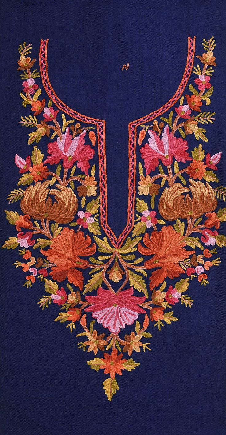 an embroidered blue shirt with flowers and leaves on it