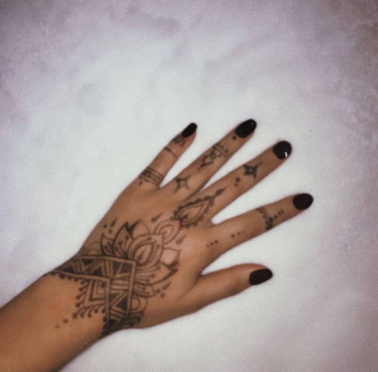 a woman's hand with tattoos on it