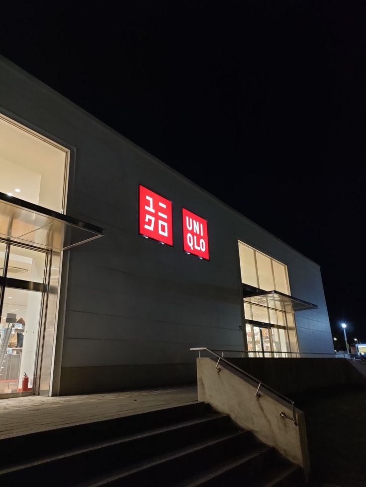 a building with stairs leading up to it at night