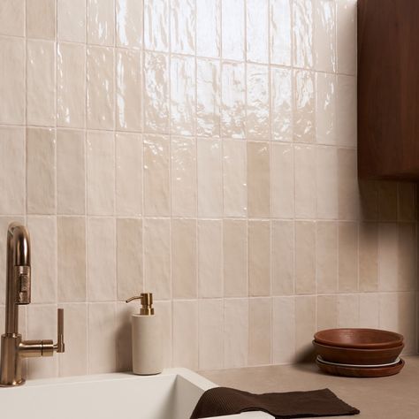 a white sink sitting next to a wooden cabinet