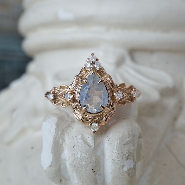 a fancy ring is sitting on top of a statue