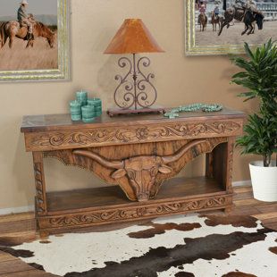 a living room with two pictures on the wall and a cowhide rug in front of it