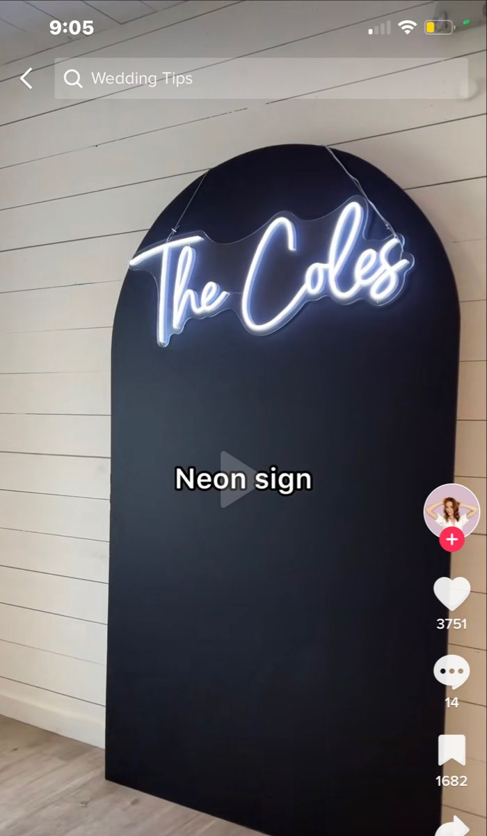 the coles neon sign is on display in front of a white wall and wooden floor