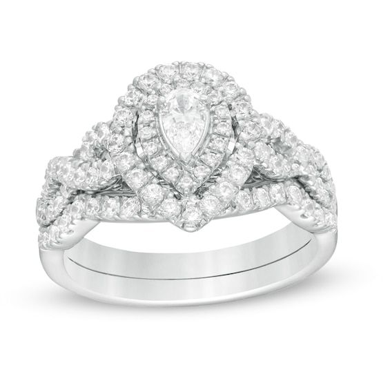 A graceful choice, this diamond bridal set complements her modern style. Fashioned in 14K white gold, the enchanting engagement ring showcases a 1/4 ct. pear-shaped diamond wrapped in a pair of diamond-lined frames. The twist ribbons of the split shank glisten with diamonds. On your wedding day, the contoured diamond-lined band completes her look. Captivating with 1 ct. t.w. of diamonds and a bright polished shine, this bridal set honors your unique love. Platinum Pear-shaped Diamond Wedding Ring, Pear-shaped Platinum Wedding Ring, White Gold Teardrop Wedding Ring With Diamond Accents, Engagement Ring Cut, Center Stone Engagement Ring, Wedding Rings Ideas, Twisted Ribbons, Pear Diamond Rings, Wedding Ring Ideas