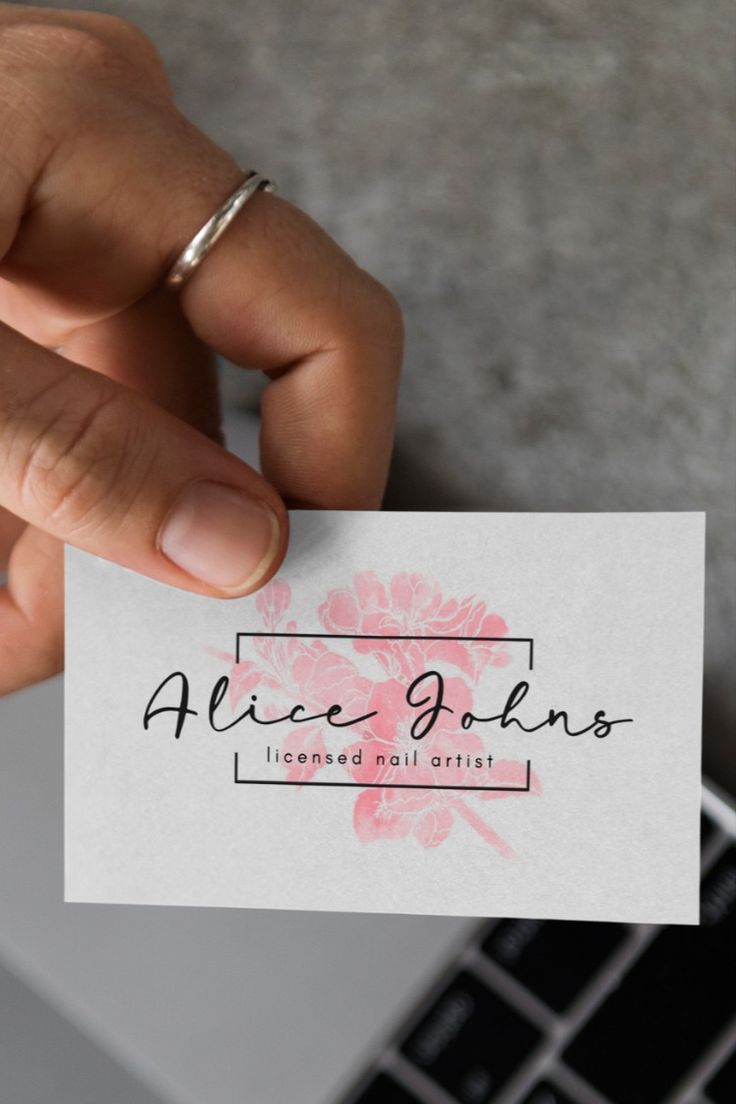 a person holding up a business card that says alice johns