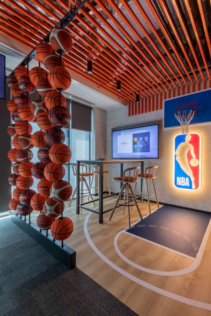 an indoor basketball court with wooden slats on the ceiling and bar stools around it