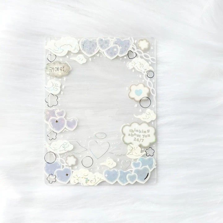 a white frame with hearts and clouds in the center on a furnishing surface