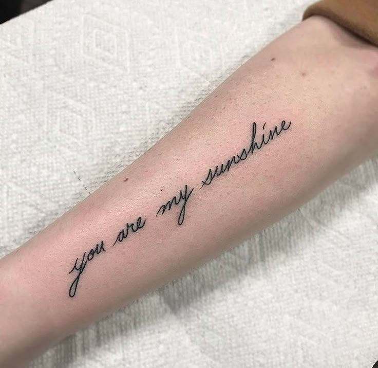 a tattoo saying you are my sunshine on the arm