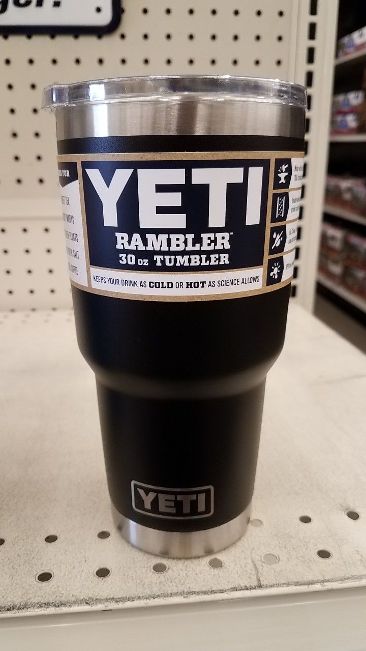 yeti rambler cup sitting on top of a shelf in a store with other items behind it