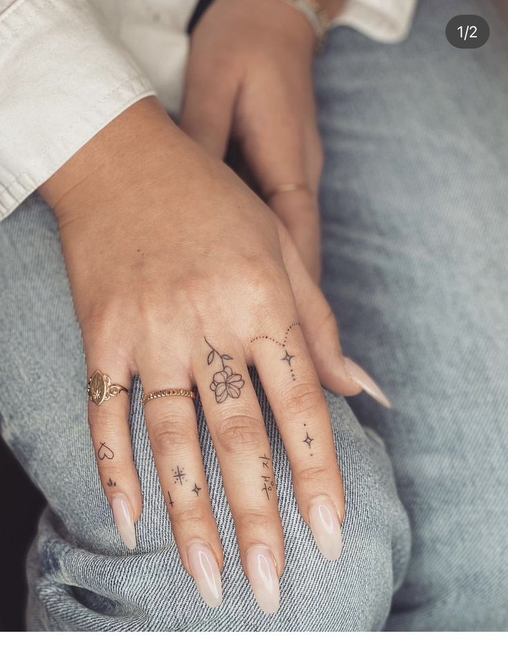 a woman's hand with tattoos on it