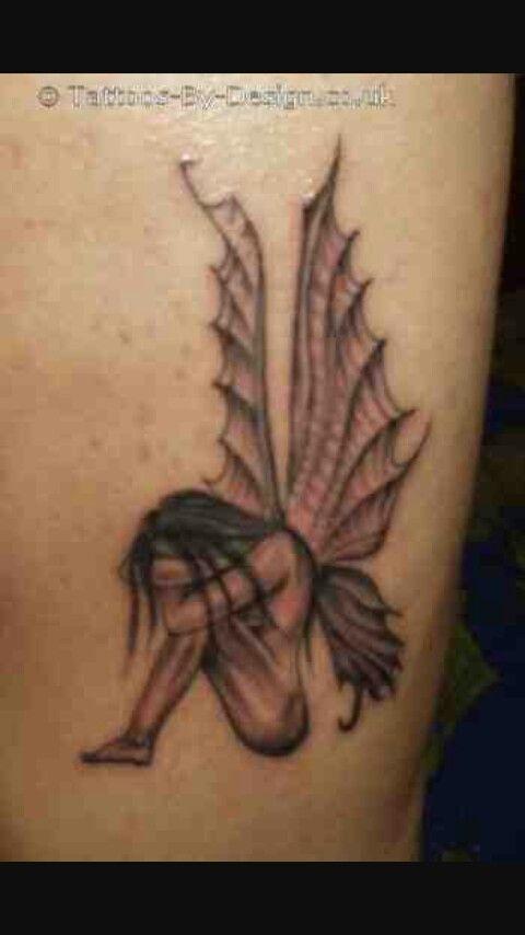 a woman's thigh with an angel tattoo on it